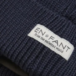 Enfant muts met oorflappen en pompom