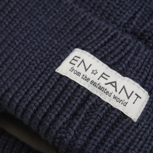 Enfant muts met oorflappen en pompom